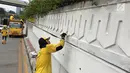 Suasana saat Pasukan Kuning mengecat dinding Underpass Kebayoran Baru, Jakarta Selatan, Kamis (1/2). Pengecatan dilakukan agar dinding underpass tidak kusam serta menghindari kesan kumuh. (Liputan6.com/Immanuel Antonius)