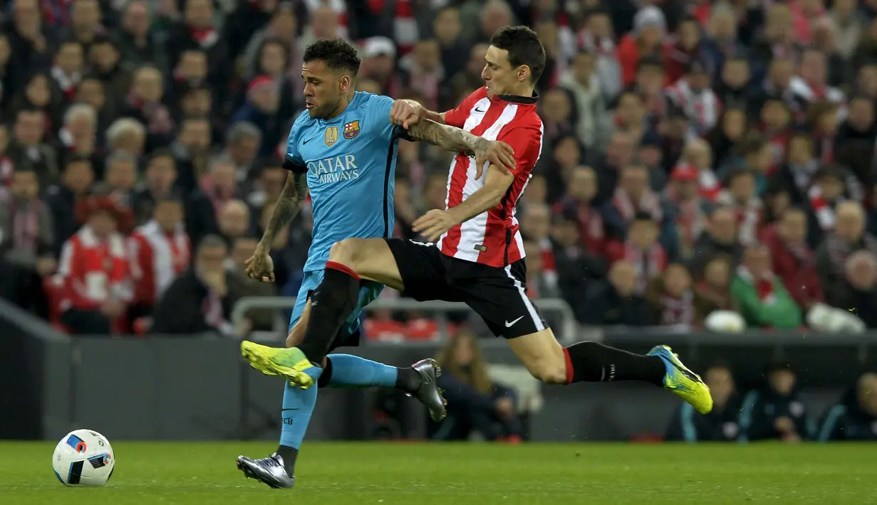 Pemain Athletic Bilbao, Aritz Aduriz (kanan) dan Pemain Barcelona, Daniel Alves da Silva  berebut bola pada Leg pertama perempat final Copa Del Rey di Stadion San Mames, Bilbao, Spanyol , Kamis (21/1/2016) dini hari WIB. (REUTERS/Vincent West)