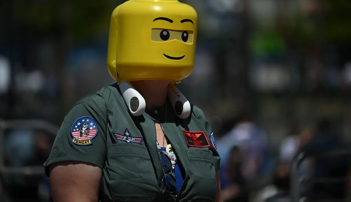 Seorang cosplayer mengenakan jaket Top Gun dan kepala lego berjalan di luar pusat konvensi selama San Diego Comic Con International 2022 di San Diego, California (22/7/2022). San Diego Comic Con 2022 berlangsung selama empat hari ini dari 21-24 Juli. (AFP Photo/Robyn Beck)