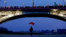 Orang-orang berdiri di jembatan saat ribuan orang berkumpul di pusat kota untuk pawai Hari Kemerdekaan tahunan di Warsawa, Polandia, 11 November 2022. Pawai diselenggarakan oleh kelompok-kelompok nasionalis yang telah ditandai dengan kekerasan dalam beberapa tahun terakhir. (AP Photo/Michal Dyjuk)