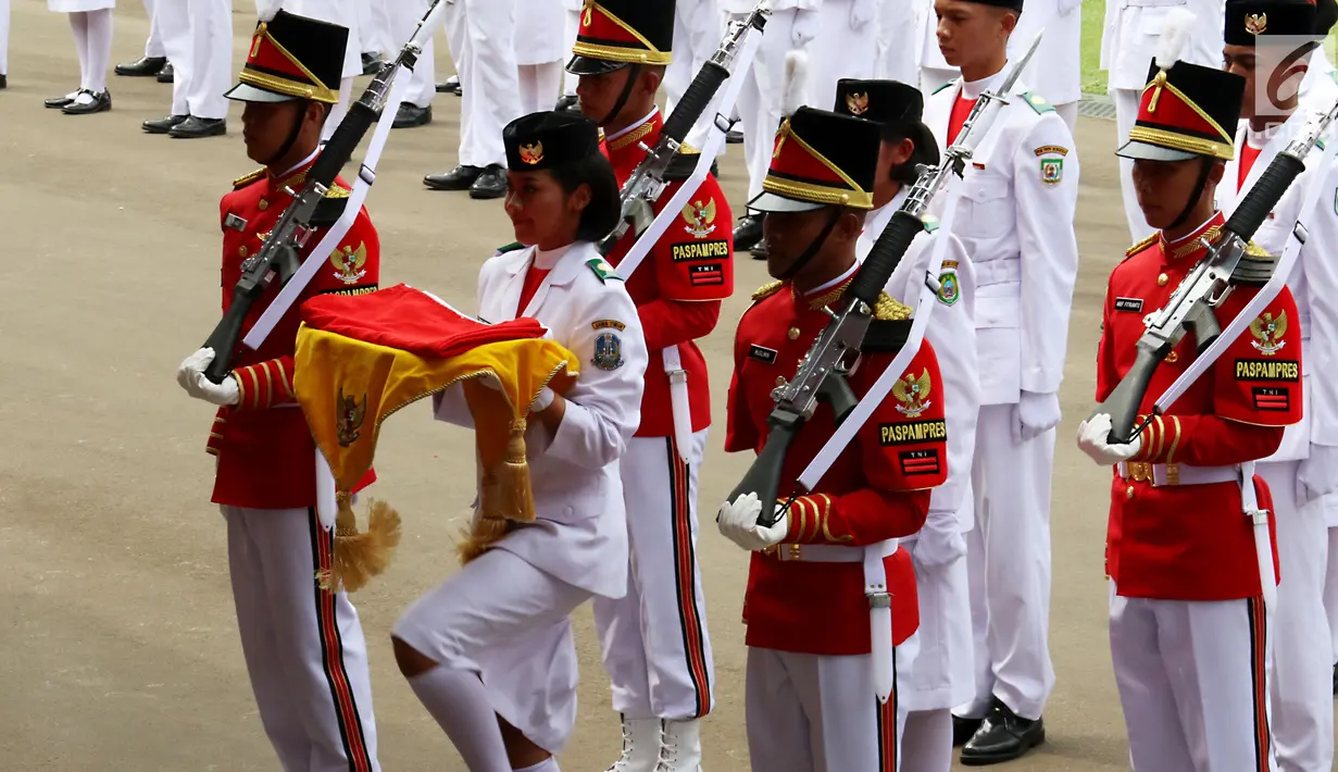 Anggota Pasukan Pengibar Bendera Pusaka (Paskibraka) asal Jawa Timur, Fariza Putri Salsabila membawa baki yang terdapat Sang Merah Putih saat Upacara Peringatan Detik-detik Proklamasi di Istana Merdeka, Jakarta, Kamis (17/8). (Liputan6.com/Pool)
