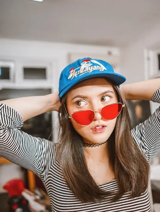 Berusia masih muda, Marsha Aruan tampil kece dengan baju motif stripe yang dipadukan dengan topi berwarna biru. Kacamata dengan lensa berwarna merah yang Marsha kenakan membuat penampilannya terlihat semakin swag.(Liputan6.com/IG/@aruanmarsha)