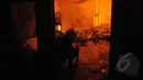 Petugas Damkar menyemprotkan air ke arah rumah warga yang dilalap api di kawasan Tanah Abang, Jakarta, Kamis (5/3/2015). Diperkirakan sekitar 200 rumah warga hangus terbakar.(Liputan6.com/Herman Zakharia)