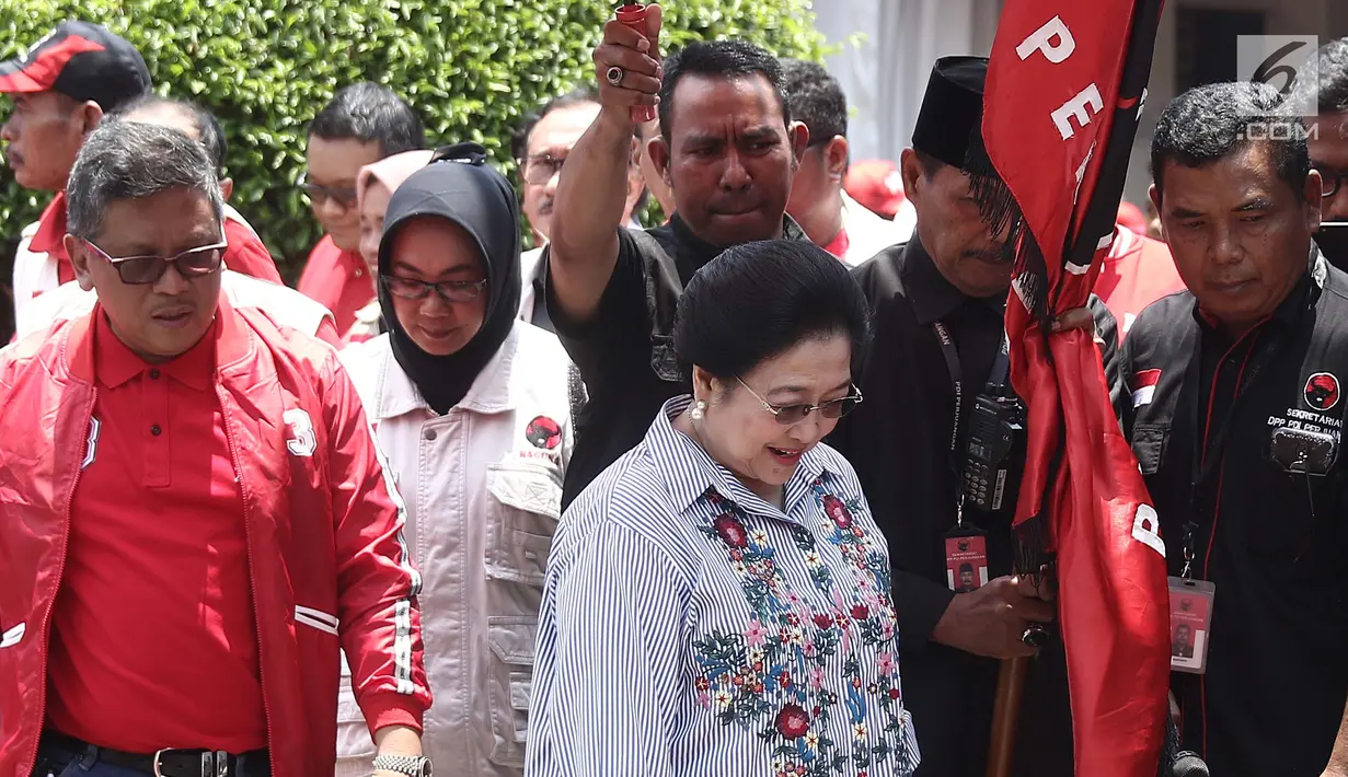 Ketum PDIP Megawati Soekarnoputri (tengah) didampingi Sekjen PDIP Hasto Kristiyanto (kiri) saat melepas bantuan untuk korban gempa dan tsunami Palu di Jakarta, Senin (8/10). PDIP memberi bantuan bahan pangan sebanyak 61 ton. (Liputan6.com/Herman Zakharia)