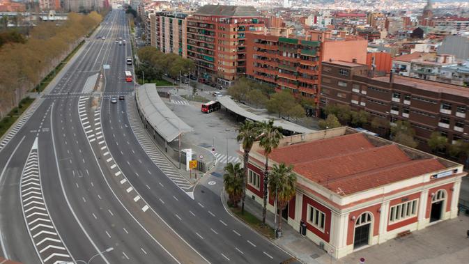 Sebuah jalan terlihat kosong di Barcelona, Spanyol, Minggu (15/3/2020). Pemerintah Spanyol memberlakukan lockdown selama 15 hari ke depan untuk menghambat penyebaran virus corona COVID-19. (AP Photo/Joan Mateu)