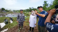 Bupati Banyuwangi Ipuk Fiestiandan bersama Gary Bencheghib saat melakukan pembersihan sampah di aliran Sungai Kali Lo, di areal destinasi wisata Pantai Marina Boom, Selasa (4/10/2022).