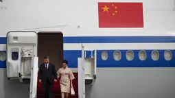 Presiden China Xi Jinping dan istrinya Peng Liyuan saat turun dari pesawat setibanya di Bandara Internasional Ngurah Rai menjelang KTT G20 di Bali, Senin (14/11/2022). Pengawalan ketat mengiringi kedatangan Presiden China, Xi Jinping. Selain pasukan pengamanan yang disiapkan oleh Indonesia, Presiden Xi Jinping juga diiringi pasukan kepercayaan dari negera Tirai Bambu ini. (Ajeng Dinar Ulfiana/Pool Photo via AP)