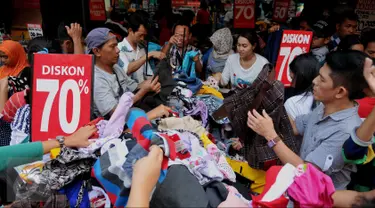 Warga memilih pakaian di kawasan perbelanjaan Pasar Baru, Jakarta, Minggu (26/6). Menjelang lebaran sejumlah toko mulai memberikan potongan harga untuk menarik pembeli. (Liputan6.com/Gempur M Surya)