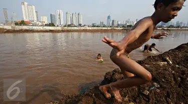 Anak-anak berenang di aliran air Kanal Banjir Barat, Jakarta, Kamis (26/11/2015). Dalamnya kali tidak menjadi penghalang bagi anak-anak tersebut untuk tetap bermain, meskipun berbahaya bagi keselamatan mereka. (Liputan6.com/Immanuel Antonius)