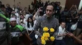 Terdakwa kasus dugaan korupsi pengadaan Chromebook dalam program digitalisasi pendidikan di Kemendikbudristek, Nadiem Anwar Makarim bersama pengemudi ojek online sebelum sidang vonis di Pengadilan Tipikor, Jakarta, Selasa (30/06/2026). (Kapanlagi.com/Budy Santoso)