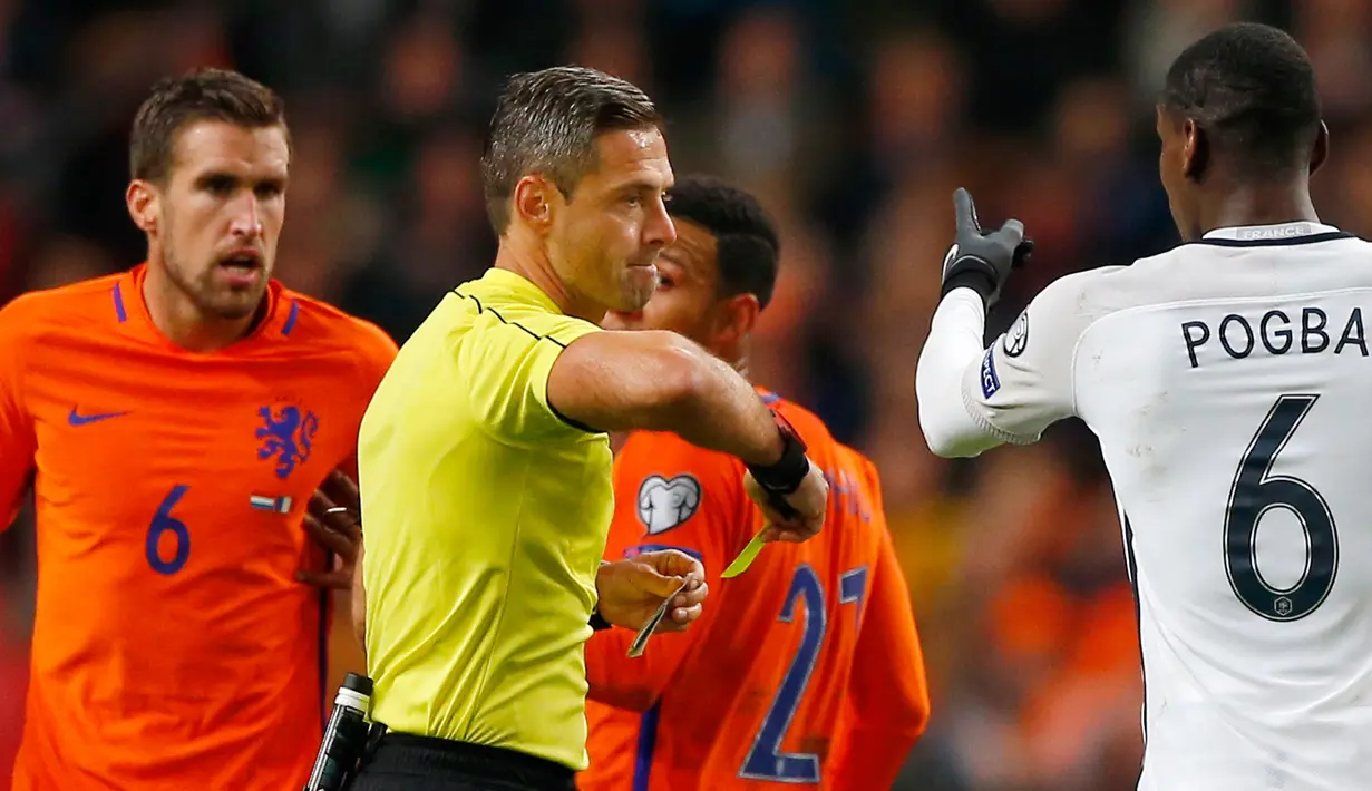 Paul Pogba dan Kevin Strootman menerima kartu kuning dari sang wasit akibat beradu mulut dalam pertandingan Prancis melawan Belanda di kualifikasi Piala Dunia 2018, Belanda, Senin (10/10). (AP Photo/Peter Dejong)