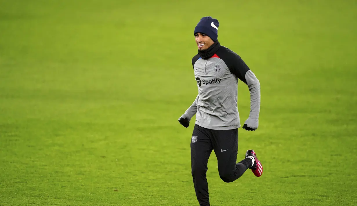 Penyerang Barcelona, Raphinha melakukan pemanasan selama sesi latihan di Old Trafford, Manchester, Inggris, Rabu 22 Februari 2023. Di leg pertama di Estadio Camp Nou, mereka ditahan imbang 2-2 Manchester United. (Martin Rickett/PA via AP)