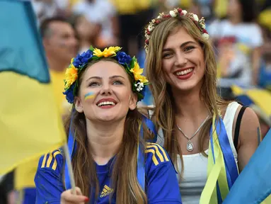 Dua Suporter cantik Ukraina terlihat bersemangat mendukung timnya berlaga melawan Polandia pada Euro 2016 di Stadion Velodrome, Marseille, Rabu (22/6/2016) dini hari WIB. (AFP/Bertrand Langlois)