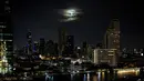 Bulan terlihat selama gerhana bulan total di atas cakrawala Bangkok, Thailand pada Rabu (26/5/2021). Gerhana hari Rabu adalah yang pertama dalam lebih dari dua tahun dan bertepatan dengan supermoon. (Jack TAYLOR / AFP)