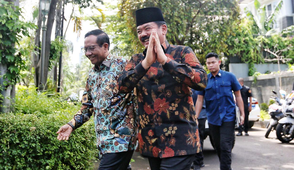 Mantan Menteri Koordinator Bidang Politik, Hukum, dan Keamanan (Menko Polhukam) Mahfud Md (kiri) menyambut kehadiran Menko Polhukam Hadi Tjahjanto di Jakarta, Kamis (22/2/2024). (Liputan6.com/Angga Yuniar)