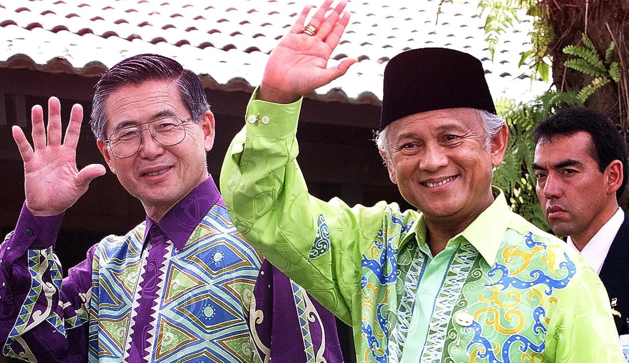 Presiden BJ Habibie (kanan) bersama Presiden Peru Alberto Fujimori melambaikan tangan saat mereka makan siang pada hari kedua KTT APEC di Cyberjaya, Malaysia, 18 November 1998. (Jonathan Utz/AFP)