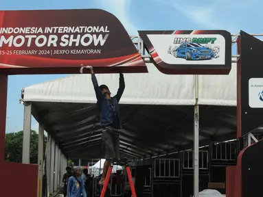 Pekerja menyelesaikan pembuatan stand pameran Indonesia International Motor Show 2024 di Jakarta International Expo (JIexpo), Jakarta Senin (12/2/2024). (merdeka.com/Imam Buhori)