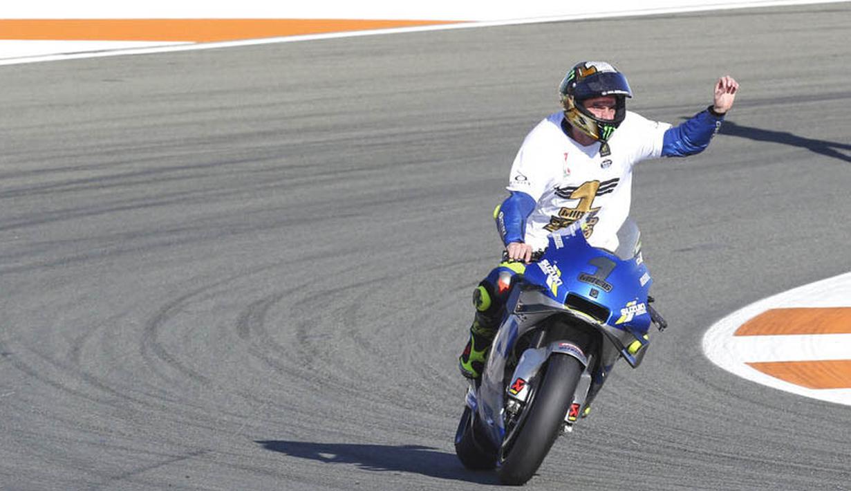 Pembalap Suzuki Esctar, Joan Mir, melakukan selebrasi usai balapan MotoGP Valencia di Sirkuit Ricardo Tormo, Minggu (15/11/2020). Meski finis ketujuh, Joan Mir berhasil mengunci gelar juara dunia MotoGP 2020. (AP/Alberto Saiz)