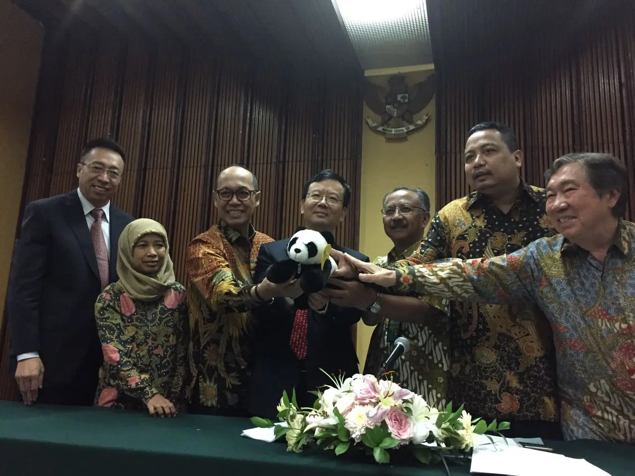 PLT Duta Besar China untuk Indonesia Sun Weide, didampingi pihak Kementerian LHK RI, Direktur Kargo Garuda Indonesia, dan pihak Taman Safari Indonesia memegang boneka panda sebagai simbol penyambutan Giant Panda (Liputan6/Teddy Tri Setio Berty)