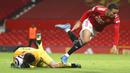 Penyerang Manchester United, Mason Greenwood, terjatuh saat berebut bola dengan kiper West Ham United, Lukasz Fabianski, pada laga Liga Inggris di Stadion Old Trafford, Minggu (15/3/2021). Setan Merah menang dengan skor 1-0. (AP/Clive Brunskill,Pool)