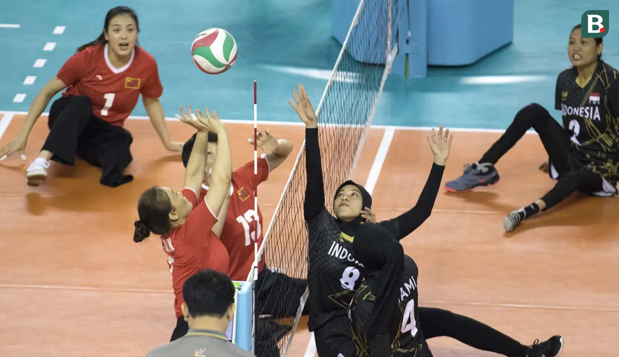 Nina Gusmita atlet voli Indonesia melakukan blok saat semifinal bola voli duduk melawan China pada  Asian Para Games 2018, di Tennis Indoor Gelora Bung Karno Jakarta, Rabu (10/10/2018).  (Bola.com/Peksi Cahyo)