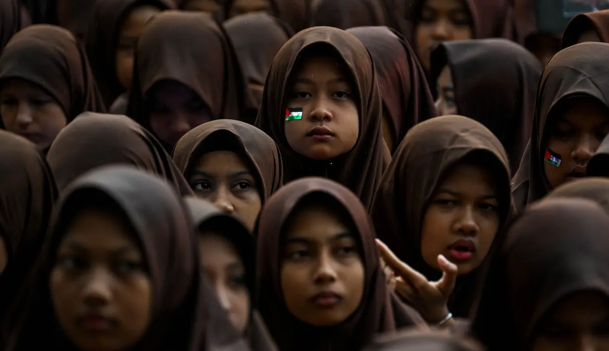 Para siswa Sekolah Menengah Pertama (SMP) Islam mengambil bagian dalam doa bersama khusus untuk mendukung perjuangan Palestina di Banda Aceh pada 20 Oktober 2023. (CHAIDEER MAHYUDDIN/AFP)