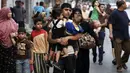 Puluhan keluarga beserta anak-anak harus keluar dari Shujayeh, (20/7/2014), menyusul meningkatnya serangan militer Israel ke Gaza, Palestina. (REUTERS/Finbarr O'Reilly)
