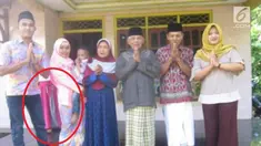 Sebuah penampakan tertangkap kamera pada sebuah foto keluarga.