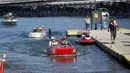 Sebuah 1965 Amphicar (kiri) dikemudikan Dean Baker dan Amphicar 1963 dikemudikan oleh Rob Vondracek saat festival Las Vegas Amphicar Swim di Danau Mead, Nevada, Jumat (9/10). (REUTERS/Steve Marcus)