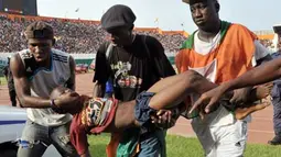 Supporters carry a lifeless body  on March 29, 2009 at Felix Houphouet-Boigny stadium in Abidjan during the World Cup 2010 and African Cup of Nations qualification match between Ivory Coast and Malawi. AFP PHOTO/ISSOUF SANOGO