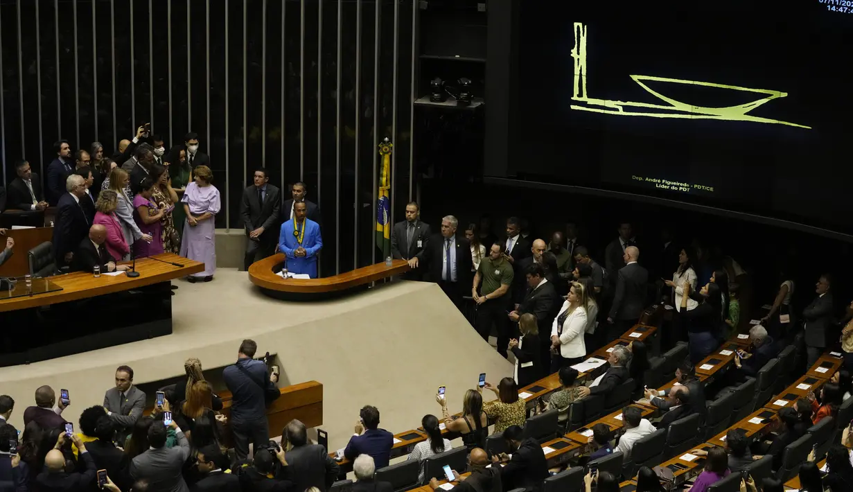Pembalap Formula 1 Mercedes asal Inggris, Lewis Hamilton, berbicara kepada para penggemar dan anggota parlemen di Chamber of Deputies selama upacara di mana ia menerima gelar Warga Kehormatan Brasil di Brasilia, Brasil (7/11/2022). Hamilton punya banyak fans di Brasil karena balapan Formula 1 dan juga respeknya untuk juara dunia tiga kali dan pahlawan Brasil Ayrton Senna, yang tewas dalam kecelakaan di Imola, Italia pada 1994. (AP Photo/Eraldo Peres)