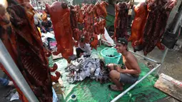 Pedagang menyiapkan babi panggang untuk perayaan Tahun Baru Imlek di Phnom Penh, Kamboja, Jumat (24/1/2020). Sejumlah pedagang di Phnom Penh sudah menjajakan daging babi panggang untuk perayaan Imlek. (AP photo/Heng Sinith)