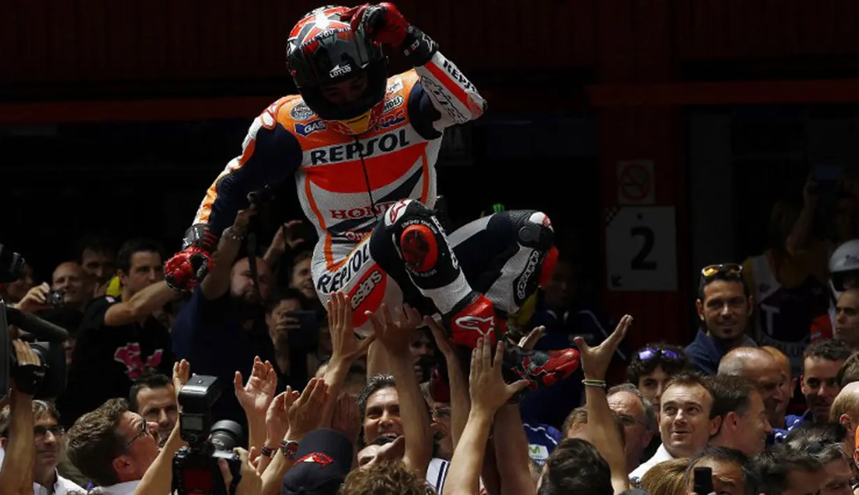 Marc Marquez dilempar ke udara oleh tim Repsol Honda usai menjadi yang tercepat di GP Katalunya, Barcelona, (15/6/2014). (REUTERS/Quique Garcia)