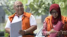 Pejabat Pembuat Komitmen Dinas PU, Bina Marga, dan SDA Kabupaten Sidoarjo, Judi Tetrahastoto (kiri) dan Kepala Dinas PU, Bina Marga, dan SDA Kabupaten Sidoarjo, Sunarti Setyaningsih berjalan akan menjalani pemeriksaan di Gedung KPK, Jakarta, Kamis (16/1/2020).  (merdeka.com/Dwi Narwoko)