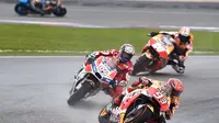 Duo Repsol Honda, Marc Marquez (depan) dan Dani Pedrosa (belakang), mengapit pebalap Ducati, Andrea Dovizioso, pada balapan MotoGP Malaysia di Sirkuit Sepang, Minggu (29/10/2017). (Motorsport)