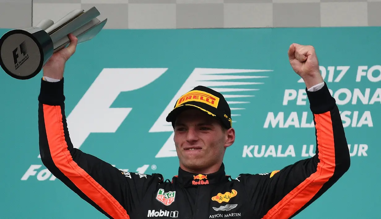 Pembalap Red Bull asal Belanda, Max Verstappen merayakan kemenangan di podium setelah menjuarai Formula 1 Grand Prix Malaysia di Sepang, Minggu (01/10) (AFP PHOTO / MANAN VATSYAYANA)