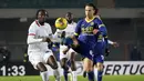 Pemain AC Milan, Tammy Abraham (kiri) berebut bola dengan pemain Hellas Verona, Daniele Ghilardi pada laga lanjutan Liga Italia 2024/2025 di Marcantonio Bentegodi, Verona, Italia, Sabtu (21/12/2024) dini hari WIB. (AP Photo/LaPresse/Paola Garbuio)