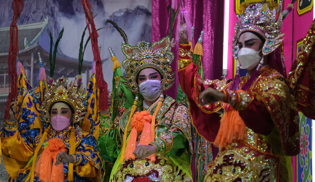 Pemain opera Tiongkok memakai masker saat tampil di atas panggung di Bangkok, Rabu (6/10/2021). Sempat vakum, pertunjukan opera Tiongkok di Thailand kembali dihidupkan meski belakangan ini kasus harian Covid-19 kembali meningkat. (AP Photo/Sakchai Lalit)