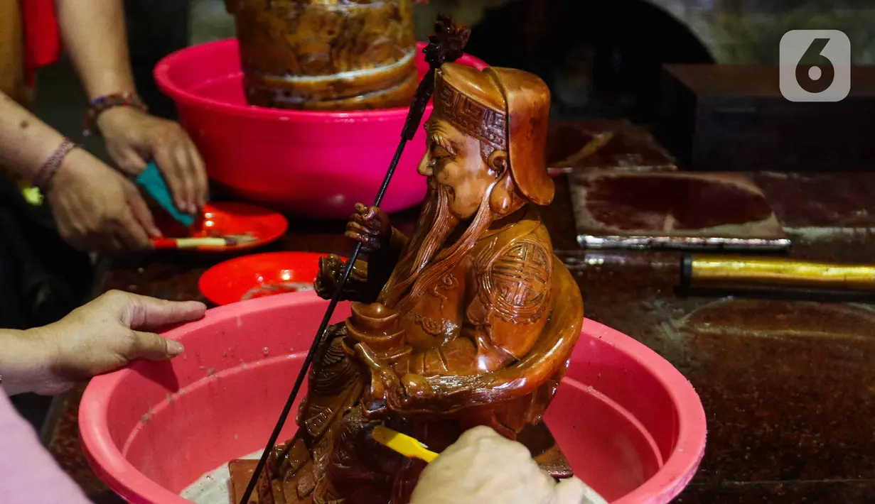 Makna ritual mencuci patung dewa jelang Imlek dilakukan sebagai bentuk penghargaan terhadap dewa dewi yang turun dari langit. (Liputan6.com/Herman Zakharia