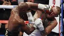 Floyd Mayweather Jr. melepaskan pukulan ke wajah Conor McGregor pada gelaran Tinju Dunia super welterweight boxing di MGM Arena, Las Vegas, (26/8/2017). Mayweather menang TKO atas McGregor. (AP/Eric Jamison)