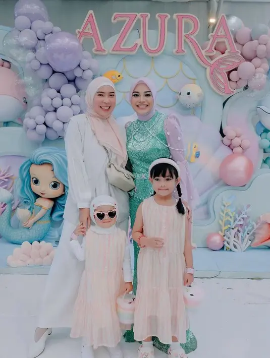 Fitri Tropica hadir bersama kedua putrinya mengenakan busana sentuhan warna putih dan peach. [@aurelie.hermansyah].