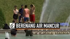 Gelombang panas yang melanda Paris membuat warga dan para turis memenuhi air mancur Trocadero. Mereka berupaya mendinginkan tubuh mereka dengan cara berenang di air mancur tersebut.