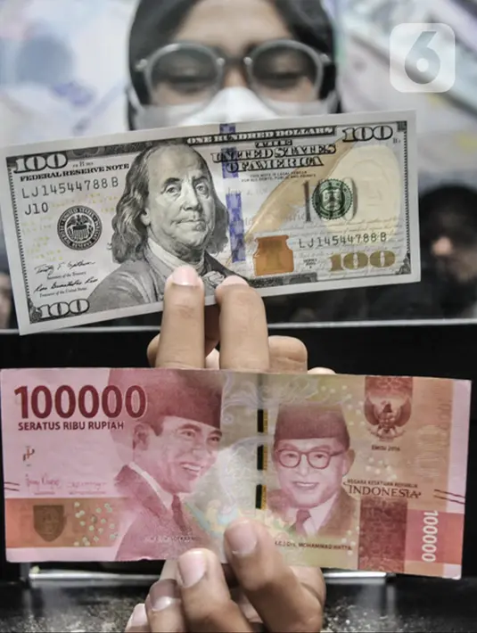 Pegawai menunjukkan uang pecahan 100 USD di salah satu gerai money changer di Jakarta, Senin (4/7/2022). Melansir data Refinitiv, hingga 4 Juni 2022 pukul 11:10 WIB rupiah melemah 0,15 persen ke Rp14.957 per USD 1. (merdeka.com/Iqbal S Nugroho)