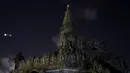 Gerhana bulan parsial mulai terlihat di sebelah monumen di Jimbaran, Bali, Indonesia, Sabtu Sabtu (4/4/2015). (AFP PHOTO/Sonny TUMBELAKA)