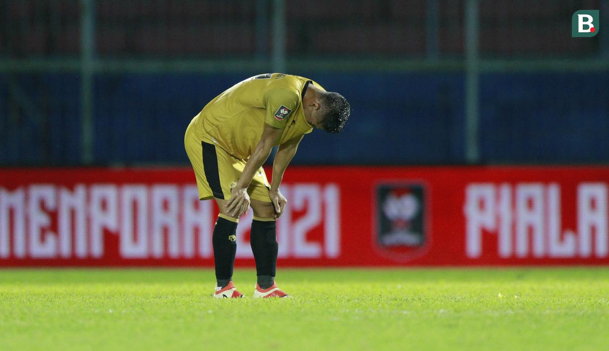 Pemain Bhayangkara Solo FC, Indra Kahfi, menangis usai ditaklukkan Persija Jakarta pada laga Piala Menpora 2021 di Stadion Kanjuruhan, Malang, Rabu (31/3/2021). Persija Menang dengan skor 2-1. (Bola.com/M Iqbal Ichsan)