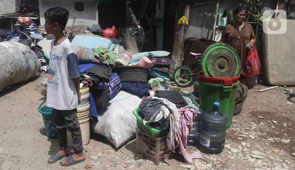 Warga mengamankan barang berharga saat api membakar pemukiman di kawasan Jalan Kebayoran Lama, Jakarta, Minggu (30/10/2022). Sebanyak 20 unit mobil damkar dikerahkan. Total sekitar 100 personel yang turun ke lokasi memadamkan api. (Liputan6.com/Helmi Fithriansyah)