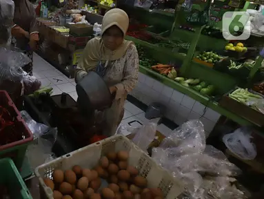 Pedagang melayani pembeli kebutuhan pokok di Pasar Santa, Jakarta, Kamis (8/12/2022). Harga bahan pokok dari sejumlah komoditas seperti cabai, bawang, daging, ayam, beras dan telur, mulai mengalami kenaikan di awal bulan Desember menjelang Natal dan Tahun Baru 2023. (Liputan6.com/Herman Zakharia)