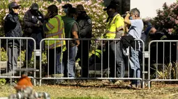 Pekerja Otoritas Transportasi Lembah Santa Clara (VTA) berkumpul di dekat railyard setelah penembakan di San Jose, California (26/5/2021). Peristiwa penembakan menewaskan  sejumlah orang. (AP Photo/Noah Berger)