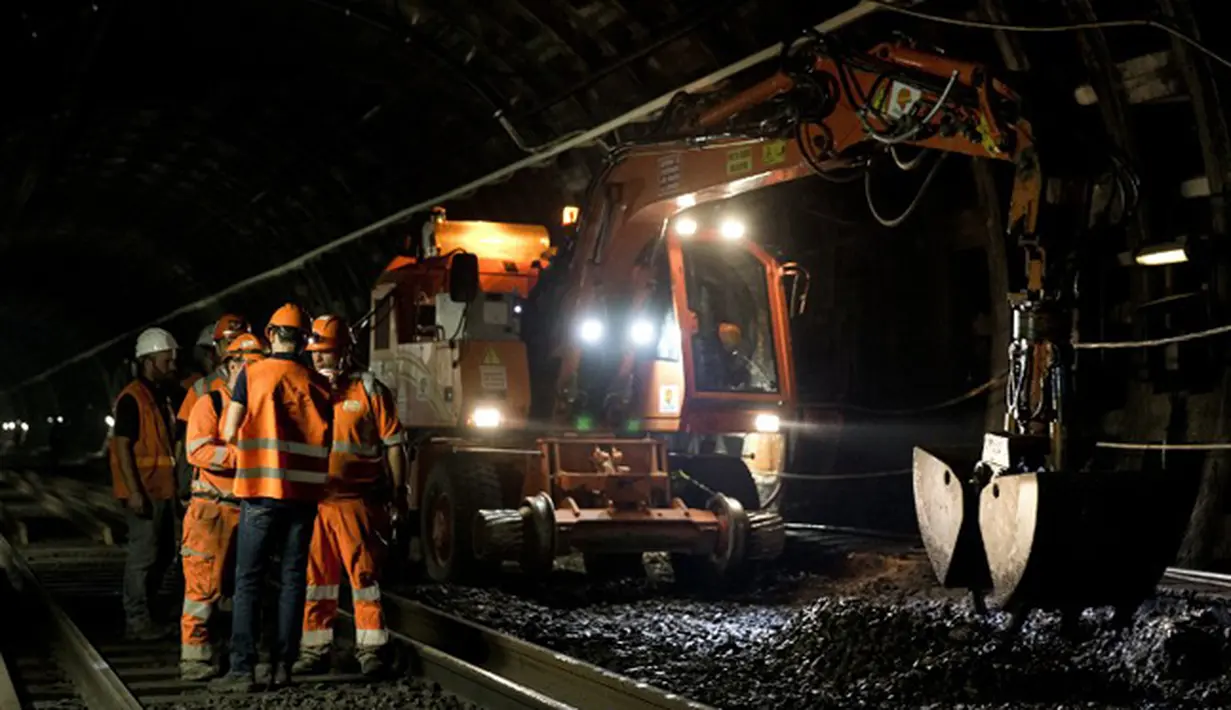 Sejumlah pekerja berdiskusi tentang pembuatan terowongan dan jalur baru kereta api antara Stasiun Charles de Gaulle-Etoile dan Auber, Paris (28/7/2015). Stasiun Charles de Gaulle-Etoile dibuka pada tanggal 1 September 1900. (AFP/KENZO TRIBOUILLARD)