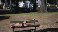 Seorang pria berjemur saat gelombang panas musim panas di bangku taman di Bosques de Palermo, Buenos Aires, Argentina (14/1/2022). Fenomena gelombang panas di Argentina sudah diperkirakan mencapai puncaknya pada minggu ini dengan temperatur mencapai 40 derajat celcius. (AP Photo/Mario De Fina)